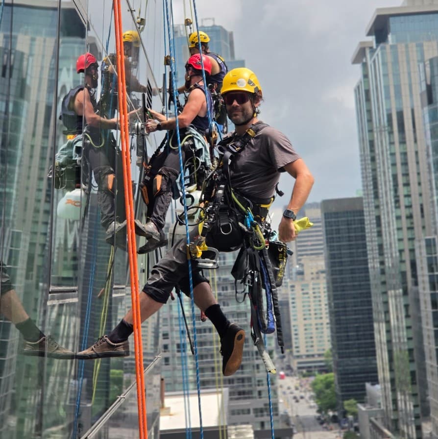 Rope-access technicians on a glass high-rise facade